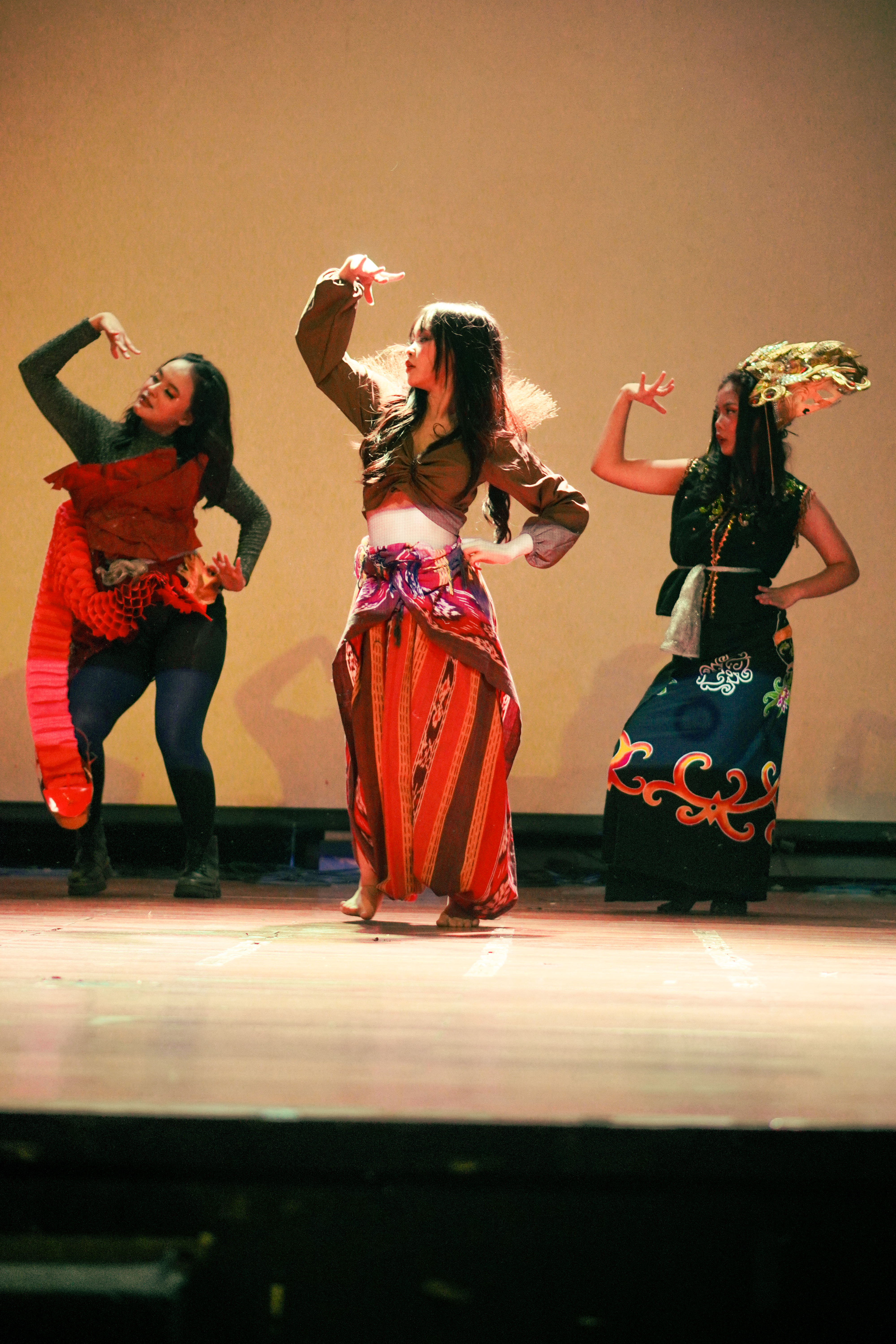 Three dancers in traditional and contemporary Indonesian costume performing on stage at Jalantari 4.0: Six Guardians of Nusantara